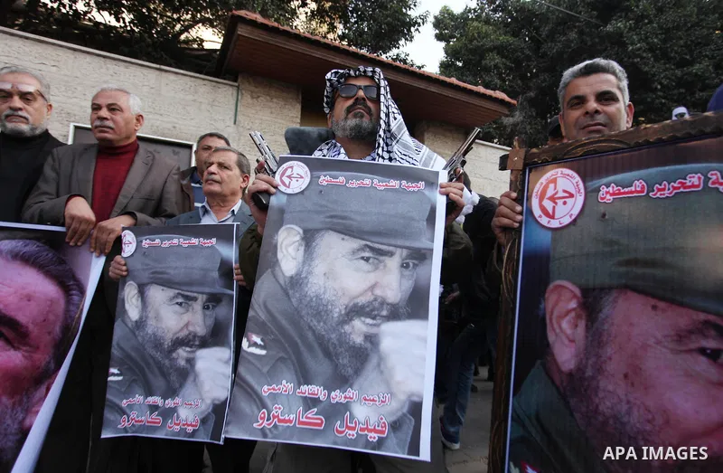 Palestinian men hold posters of late Cuban leader Fidel Castro during a gathering in Gaza city on November 28, 2016 to pay tribute him after his death. Cuban revolutionary icon Fidel Castro died late November 25 in Havan...