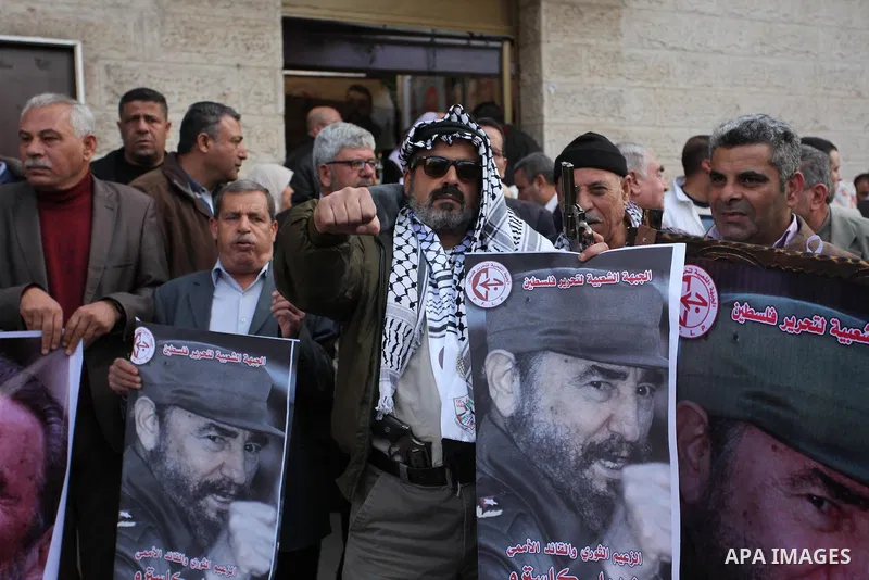 Palestinian men hold posters of late Cuban leader Fidel Castro during a gathering in Gaza city on November 28, 2016 to pay tribute him after his death. Cuban revolutionary icon Fidel Castro died late November 25 in Havan...