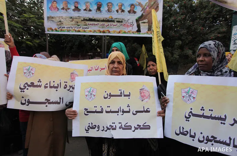 Palestinians who support Palestinian senior Fatah official Mohammed Dahlan, hold banners and national flags during a protest against Palestinian President Mahmoud Abbas in Gaza City on November 28, 2016. Photo by Ashraf...
