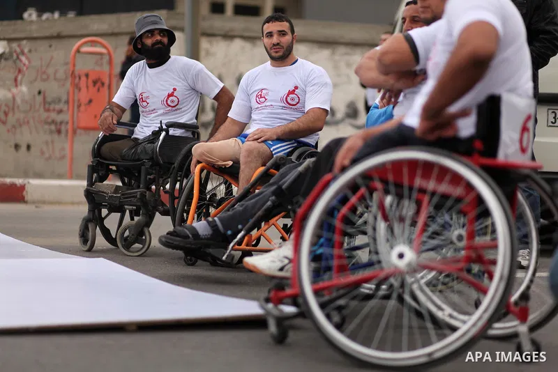 Palestinian men on wheelchairs to compete in a marathon organized for the Palestinians who have been wounded as a result of wars, in the November 29, 2016 in Gaza City. Tens of thousands of Gaza residents are learning to...