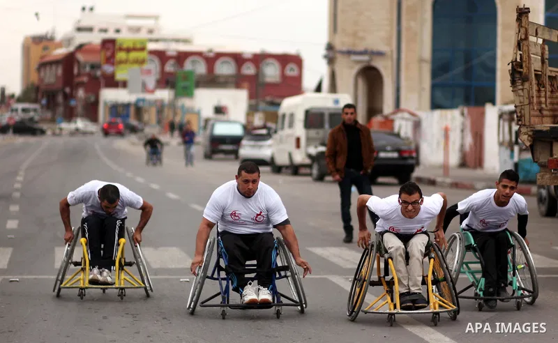 Palestinian men on wheelchairs to compete in a marathon organized for the Palestinians who have been wounded as a result of wars, in the November 29, 2016 in Gaza City. Tens of thousands of Gaza residents are learning to...