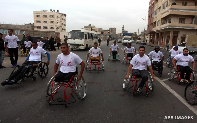 Palestinian men on wheelchairs to compete in a marathon organized for the Palestinians who have been wounded as a result of wars, in the November 29, 2016 in Gaza City. Tens of thousands of Gaza residents are learning to...