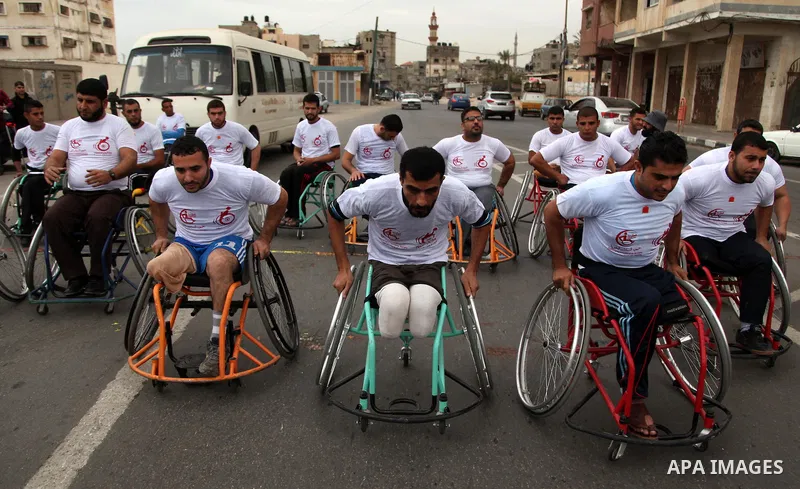 Palestinian men on wheelchairs to compete in a marathon organized for the Palestinians who have been wounded as a result of wars, in the November 29, 2016 in Gaza City. Tens of thousands of Gaza residents are learning to...