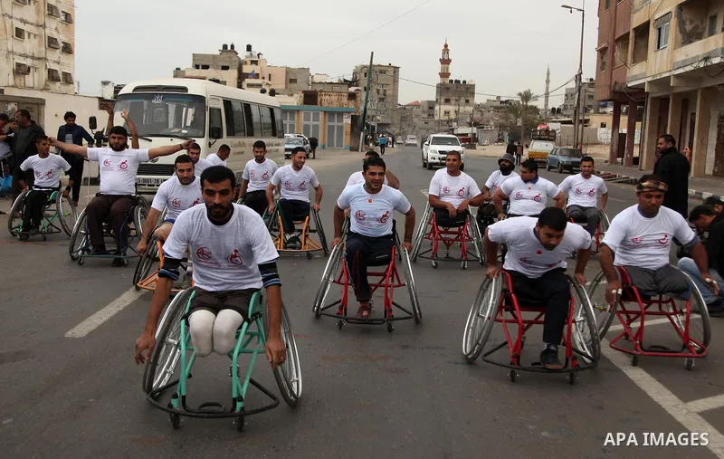 Palestinian men on wheelchairs to compete in a marathon organized for the Palestinians who have been wounded as a result of wars, in the November 29, 2016 in Gaza City. Tens of thousands of Gaza residents are learning to...
