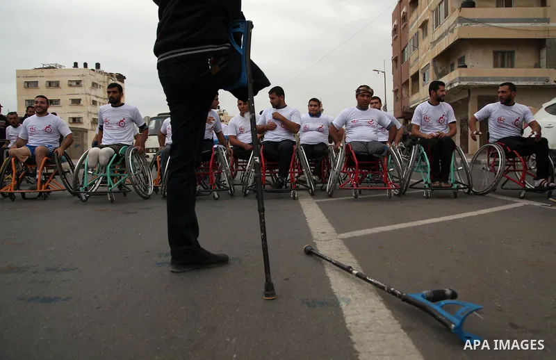 Palestinian men on wheelchairs to compete in a marathon organized for the Palestinians who have been wounded as a result of wars, in the November 29, 2016 in Gaza City. Tens of thousands of Gaza residents are learning to...