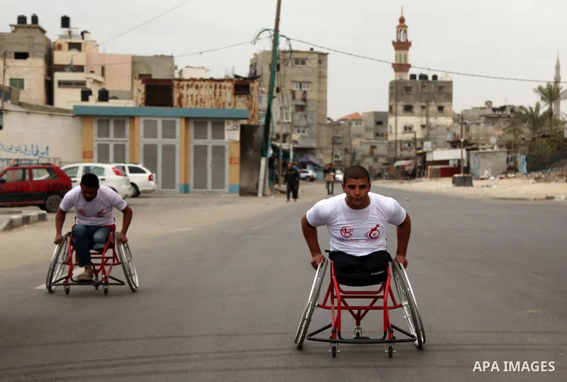 Palestinian men on wheelchairs to compete in a marathon organized for the Palestinians who have been wounded as a result of wars, in the November 29, 2016 in Gaza City. Tens of thousands of Gaza residents are learning to...