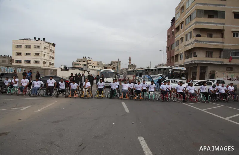 Palestinian men on wheelchairs to compete in a marathon organized for the Palestinians who have been wounded as a result of wars, in the November 29, 2016 in Gaza City. Tens of thousands of Gaza residents are learning to...