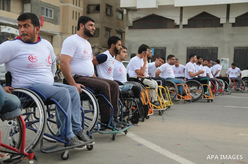 Palestinian men on wheelchairs to compete in a marathon organized for the Palestinians who have been wounded as a result of wars, in the November 29, 2016 in Gaza City. Tens of thousands of Gaza residents are learning to...