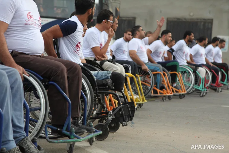 Palestinian men on wheelchairs to compete in a marathon organized for the Palestinians who have been wounded as a result of wars, in the November 29, 2016 in Gaza City. Tens of thousands of Gaza residents are learning to...