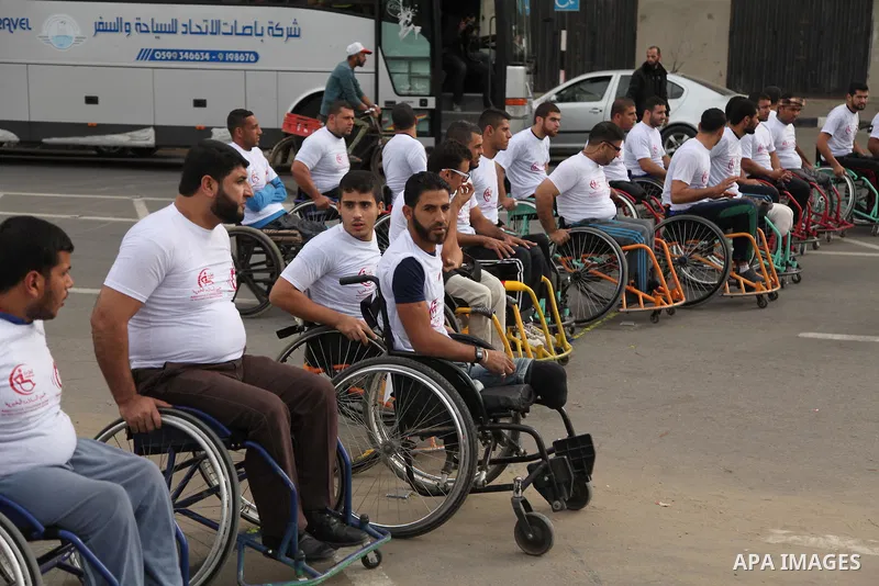 Palestinian men on wheelchairs to compete in a marathon organized for the Palestinians who have been wounded as a result of wars, in the November 29, 2016 in Gaza City. Tens of thousands of Gaza residents are learning to...