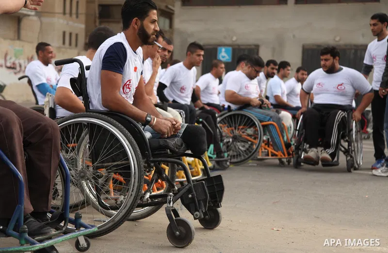 Palestinian men on wheelchairs to compete in a marathon organized for the Palestinians who have been wounded as a result of wars, in the November 29, 2016 in Gaza City. Tens of thousands of Gaza residents are learning to...