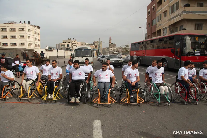 Palestinian men on wheelchairs to compete in a marathon organized for the Palestinians who have been wounded as a result of wars, in the November 29, 2016 in Gaza City. Tens of thousands of Gaza residents are learning to...