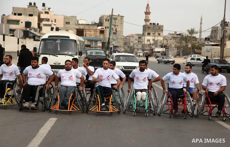 Palestinian men on wheelchairs to compete in a marathon organized for the Palestinians who have been wounded as a result of wars, in the November 29, 2016 in Gaza City. Tens of thousands of Gaza residents are learning to...