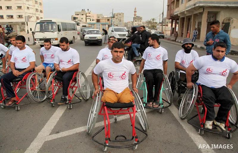 Palestinian men on wheelchairs to compete in a marathon organized for the Palestinians who have been wounded as a result of wars, in the November 29, 2016 in Gaza City. Tens of thousands of Gaza residents are learning to...