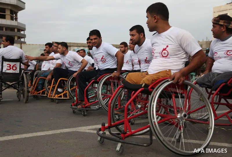 Palestinian men on wheelchairs to compete in a marathon organized for the Palestinians who have been wounded as a result of wars, in the November 29, 2016 in Gaza City. Tens of thousands of Gaza residents are learning to...