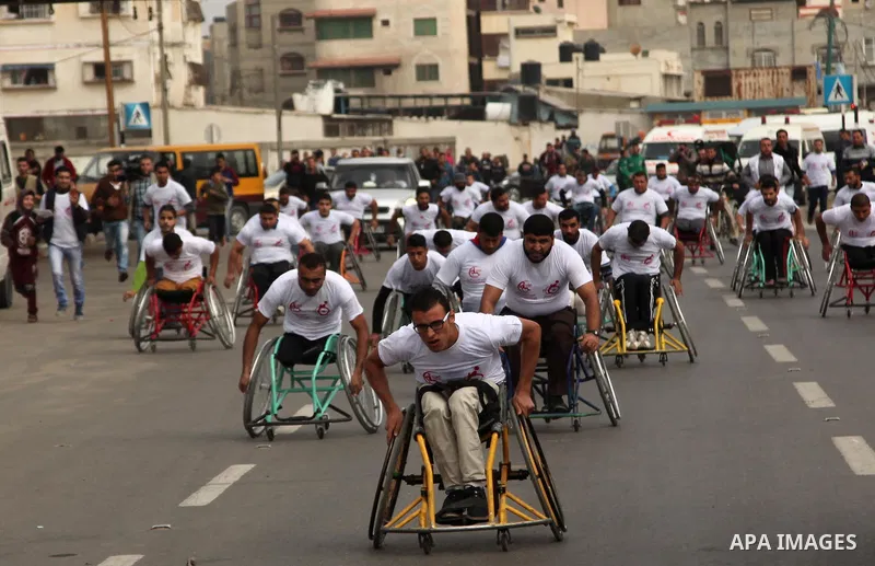 Palestinian men on wheelchairs to compete in a marathon organized for the Palestinians who have been wounded as a result of wars, in the November 29, 2016 in Gaza City. Tens of thousands of Gaza residents are learning to...