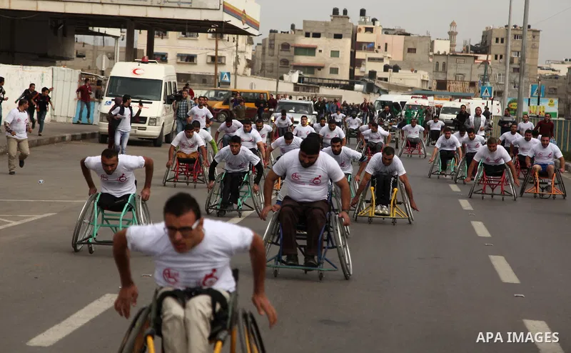 Palestinian men on wheelchairs to compete in a marathon organized for the Palestinians who have been wounded as a result of wars, in the November 29, 2016 in Gaza City. Tens of thousands of Gaza residents are learning to...