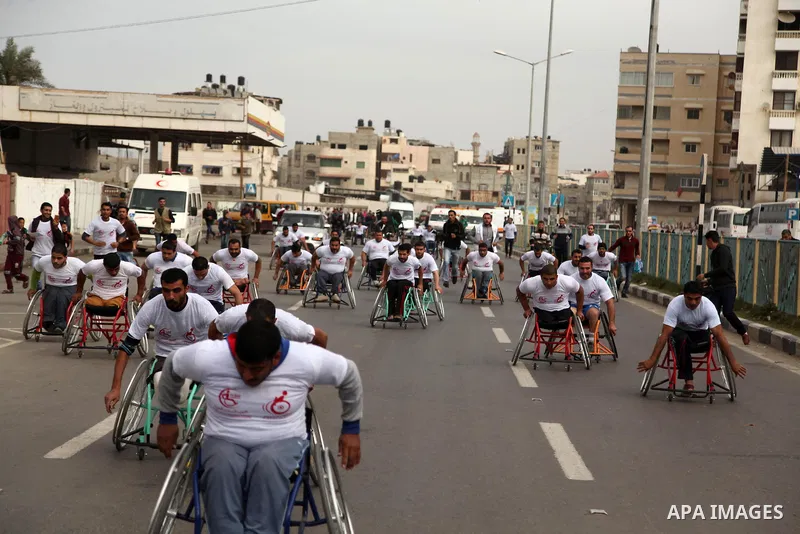 Palestinian men on wheelchairs to compete in a marathon organized for the Palestinians who have been wounded as a result of wars, in the November 29, 2016 in Gaza City. Tens of thousands of Gaza residents are learning to...