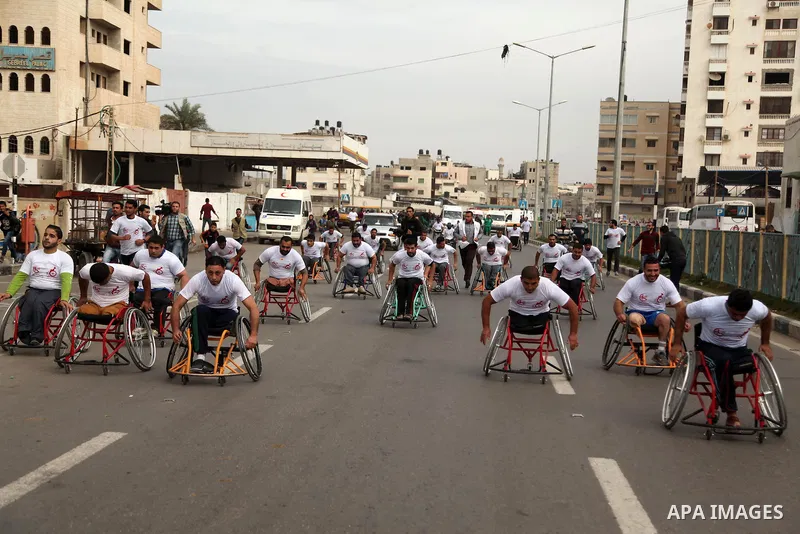 Palestinian men on wheelchairs to compete in a marathon organized for the Palestinians who have been wounded as a result of wars, in the November 29, 2016 in Gaza City. Tens of thousands of Gaza residents are learning to...