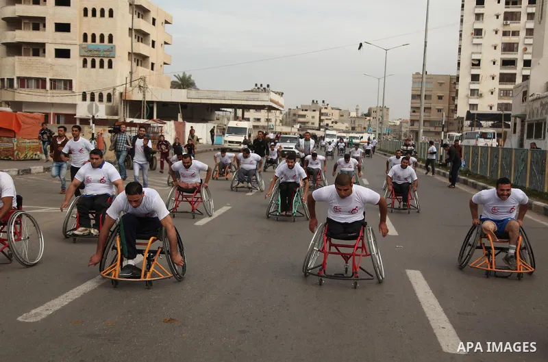Palestinian men on wheelchairs to compete in a marathon organized for the Palestinians who have been wounded as a result of wars, in the November 29, 2016 in Gaza City. Tens of thousands of Gaza residents are learning to...