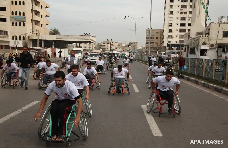 Palestinian men on wheelchairs to compete in a marathon organized for the Palestinians who have been wounded as a result of wars, in the November 29, 2016 in Gaza City. Tens of thousands of Gaza residents are learning to...