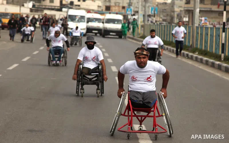 Palestinian men on wheelchairs to compete in a marathon organized for the Palestinians who have been wounded as a result of wars, in the November 29, 2016 in Gaza City. Tens of thousands of Gaza residents are learning to...