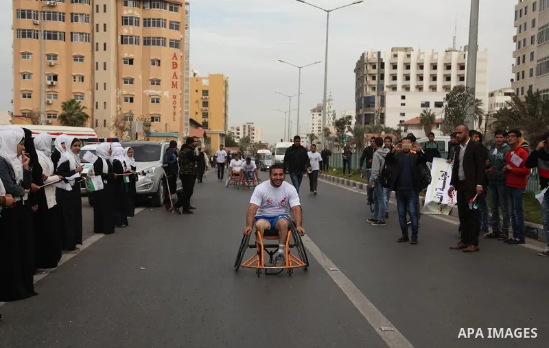 Palestinian men on wheelchairs to compete in a marathon organized for the Palestinians who have been wounded as a result of wars, in the November 29, 2016 in Gaza City. Tens of thousands of Gaza residents are learning to...