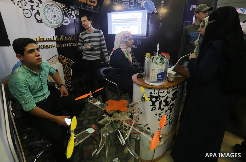 Palestinians attend to the Expotech exhibition for telecom and information technology, in Gaza City on November 30, 2016. Photo by Mohammed Asad