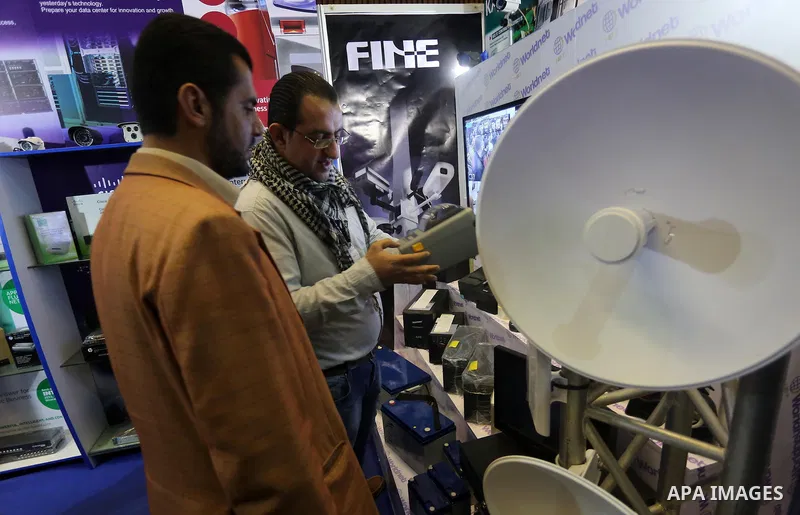 Palestinians attend to the Expotech exhibition for telecom and information technology, in Gaza City on November 30, 2016. Photo by Mohammed Asad