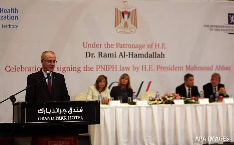 Palestinian Prime Minister Rami Hamdallah speaks during a ceremony of signing the PNIPH law, in the West Bank city of Ramallah, on Nov. 30, 2016. Photo by Prime Minister Office