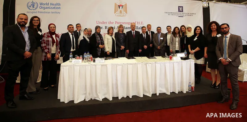 Palestinian Prime Minister Rami Hamdallah attends a ceremony of signing the PNIPH law, in the West Bank city of Ramallah, on Nov. 30, 2016. Photo by Prime Minister Office