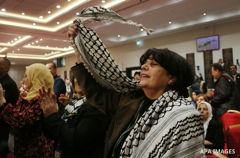 Members of the Fatah party react at the end of a speech delivered by the Palestinian president Mahmoud Abbas on the second day of the 7th Fatah Congress on November 30, 2016, at the Muqataa, the Palestinian Authority hea...