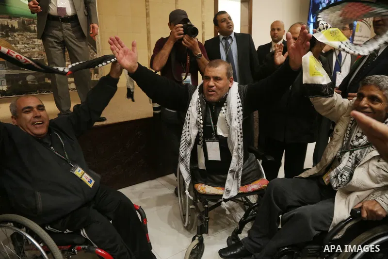 Members of the Fatah party react at the end of a speech delivered by the Palestinian president Mahmoud Abbas on the second day of the 7th Fatah Congress on November 30, 2016, at the Muqataa, the Palestinian Authority hea...