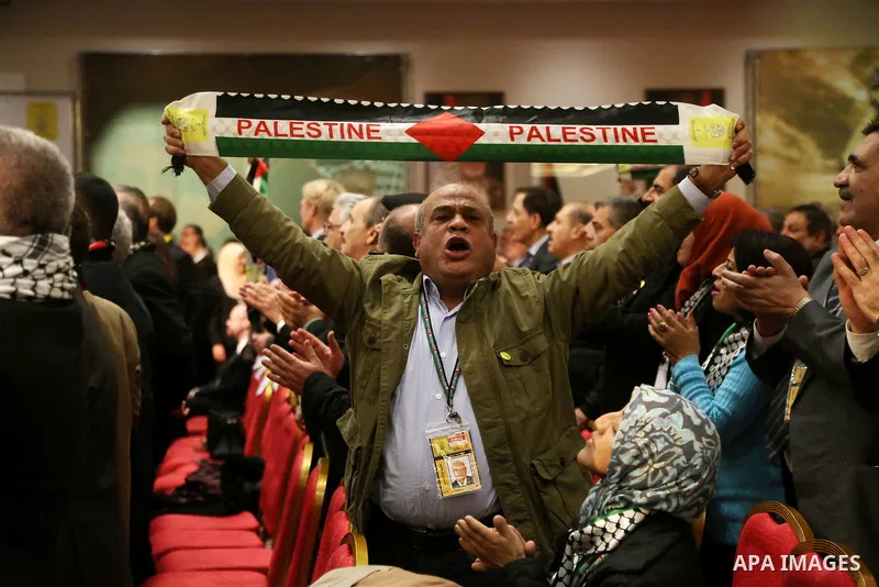 Members of the Fatah party react at the end of a speech delivered by the Palestinian president Mahmoud Abbas on the second day of the 7th Fatah Congress on November 30, 2016, at the Muqataa, the Palestinian Authority hea...
