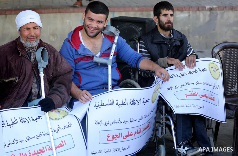 Palestinians and physically challenged people take part in a rally marking the International Day of Persons with Disabilities in Gaza City, on December 1, 2016. Photo by Yasser Qudih