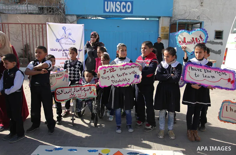 Palestinians and physically challenged people take part in a rally marking the International Day of Persons with Disabilities, outside the UNESCO headquarters in Gaza city, on December 1, 2016. Photo by Ashraf Amra