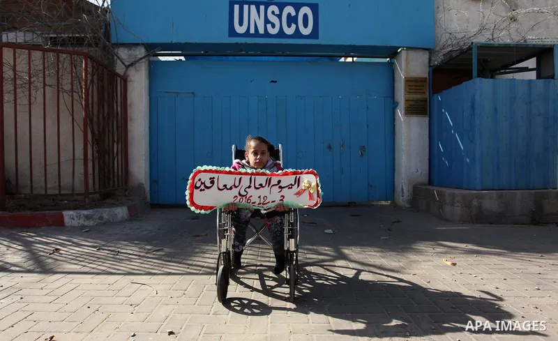 Palestinians and physically challenged people take part in a rally marking the International Day of Persons with Disabilities, outside the UNESCO headquarters in Gaza city, on December 1, 2016. Photo by Ashraf Amra