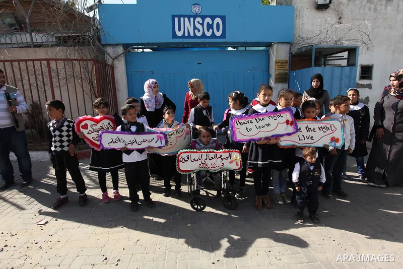 Palestinians and physically challenged people take part in a rally marking the International Day of Persons with Disabilities, outside the UNESCO headquarters in Gaza city, on December 1, 2016. Photo by Ashraf Amra