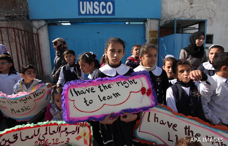 Palestinians and physically challenged people take part in a rally marking the International Day of Persons with Disabilities, outside the UNESCO headquarters in Gaza city, on December 1, 2016. Photo by Ashraf Amra