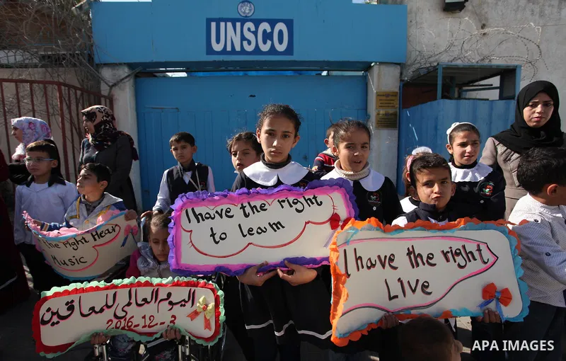 Palestinians and physically challenged people take part in a rally marking the International Day of Persons with Disabilities, outside the UNESCO headquarters in Gaza city, on December 1, 2016. Photo by Ashraf Amra