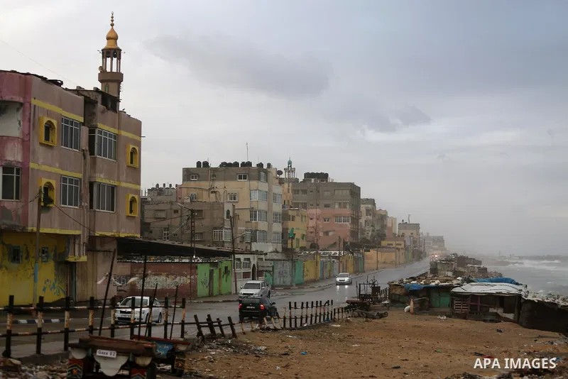 A picture taken on December 1, 2016 shows cars at a street during rain and a cold spell at the al-Shati refugee camp in Gaza City on December 1, 2016. Photo by Mohammed Asad