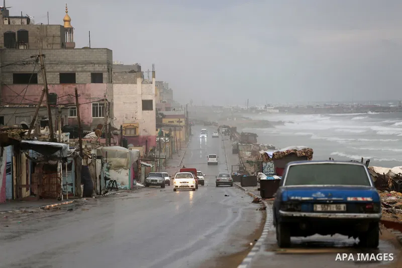 A picture taken on December 1, 2016 shows cars at a street during rain and a cold spell at the al-Shati refugee camp in Gaza City on December 1, 2016. Photo by Mohammed Asad