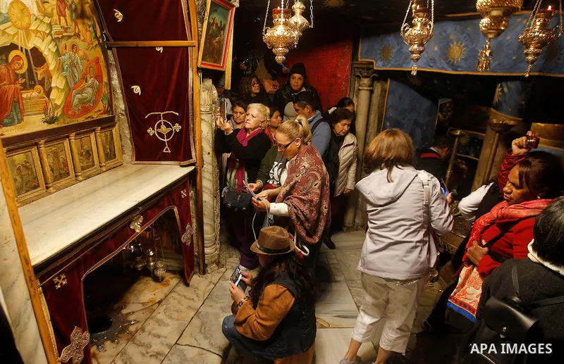 Visitors visit the holy star where Jesus Christ is believed to have been born inside the holy cave in the Church of Nativity during a Christmas tree lighting ceremony in the West Bank town of Bethlehem December 3, 2016....