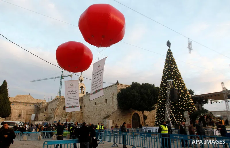 Palestinian Christians attend marking the lighting of a Christmas tree on December 3, 2016 at the Manger Square near the Church of the Nativity, revered as the site of Jesus Christ's birth, in the biblical West Bank town...