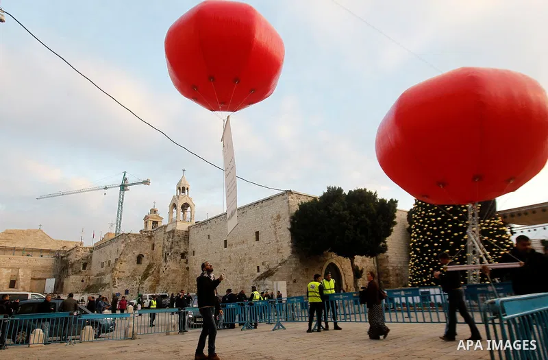Palestinian Christians attend marking the lighting of a Christmas tree on December 3, 2016 at the Manger Square near the Church of the Nativity, revered as the site of Jesus Christ's birth, in the biblical West Bank town...