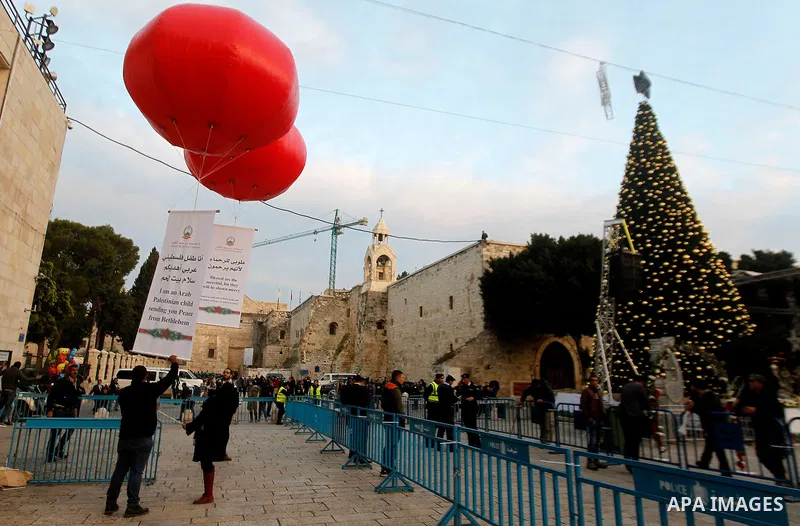 Palestinian Christians attend marking the lighting of a Christmas tree on December 3, 2016 at the Manger Square near the Church of the Nativity, revered as the site of Jesus Christ's birth, in the biblical West Bank town...