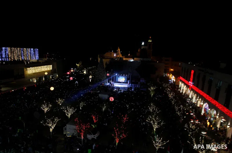Palestinian Christians watch fireworks marking the lighting of a Christmas tree on December 3, 2016 at the Manger Square near the Church of the Nativity, revered as the site of Jesus Christ's birth, in the biblical West...