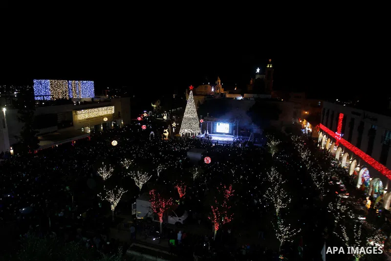 Palestinian Christians watch fireworks marking the lighting of a Christmas tree on December 3, 2016 at the Manger Square near the Church of the Nativity, revered as the site of Jesus Christ's birth, in the biblical West...