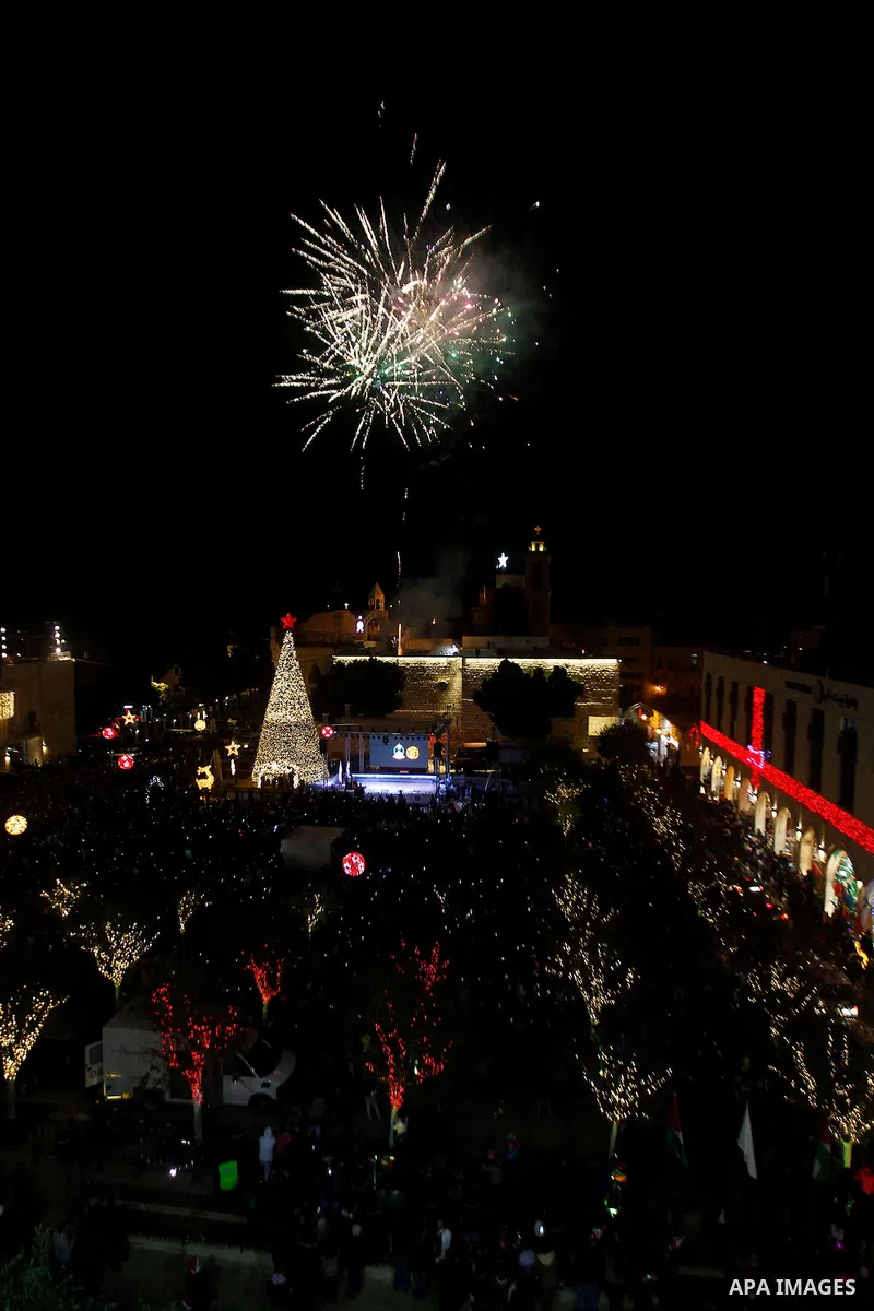 Palestinian Christians watch fireworks marking the lighting of a Christmas tree on December 3, 2016 at the Manger Square near the Church of the Nativity, revered as the site of Jesus Christ's birth, in the biblical West...
