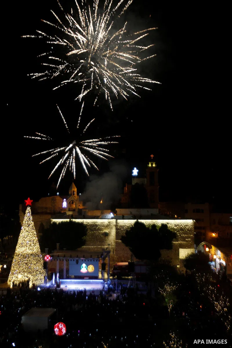 Palestinian Christians watch fireworks marking the lighting of a Christmas tree on December 3, 2016 at the Manger Square near the Church of the Nativity, revered as the site of Jesus Christ's birth, in the biblical West...